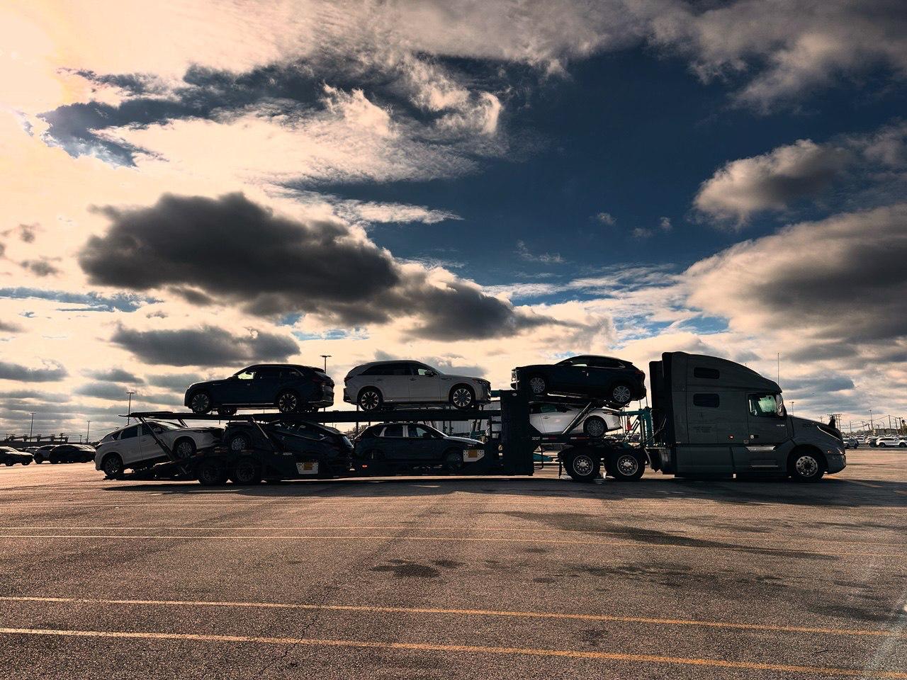 Auto carrier silhouetted beneath a dramatic sky